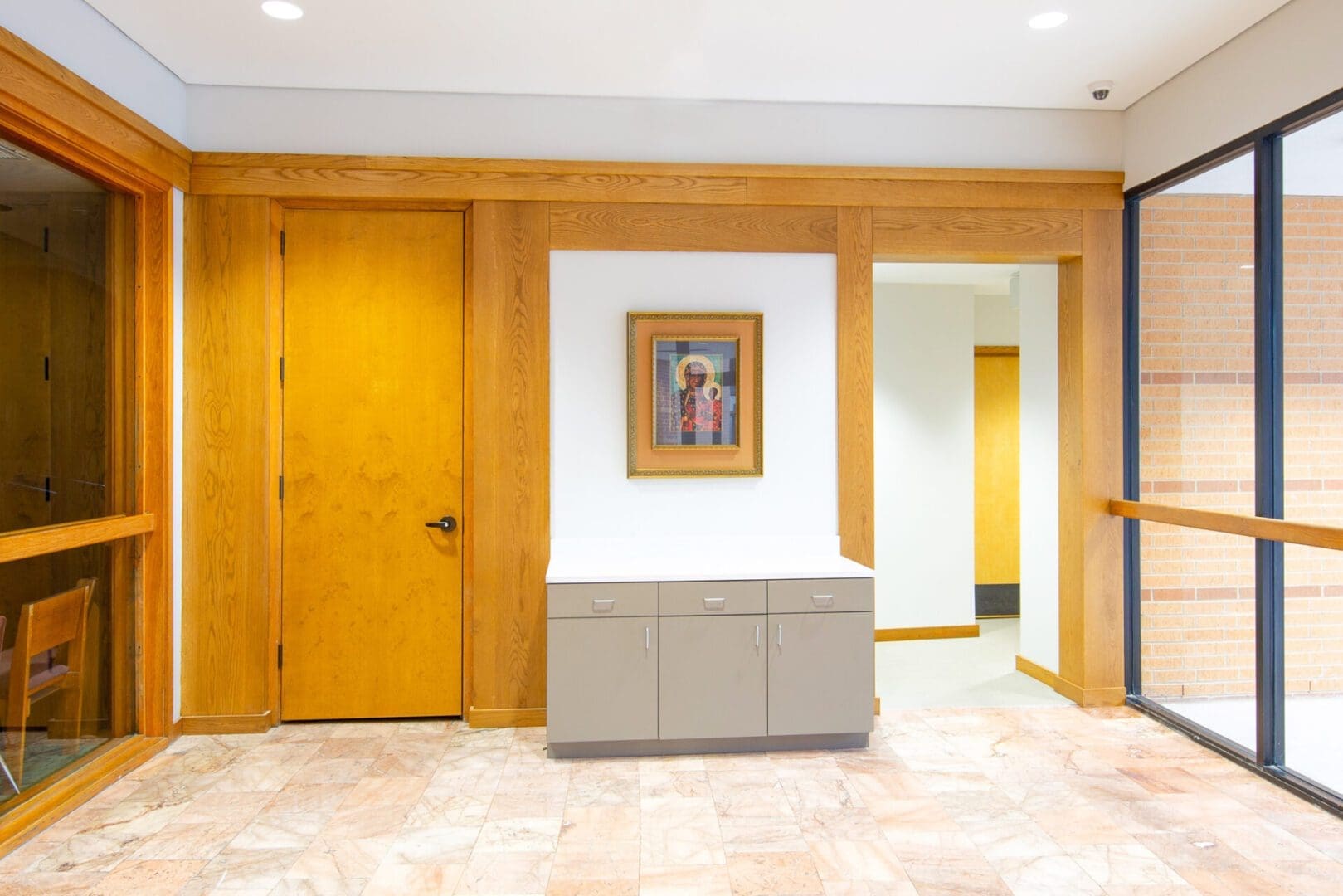 Hallway with wooden doors and artwork.