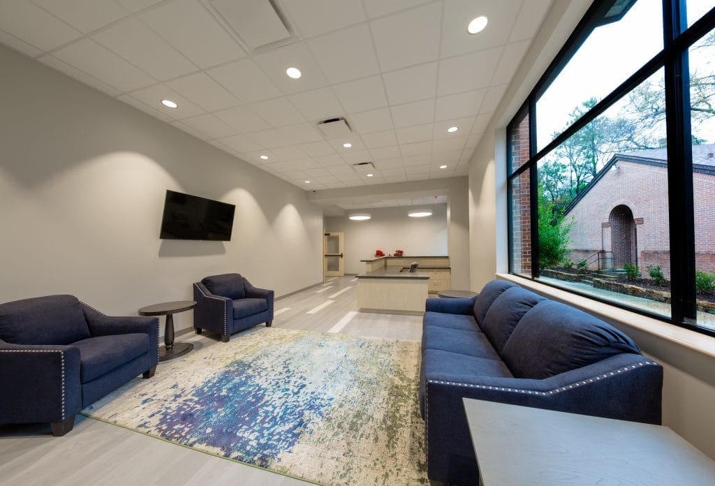 Modern office lounge with sofas and TV.