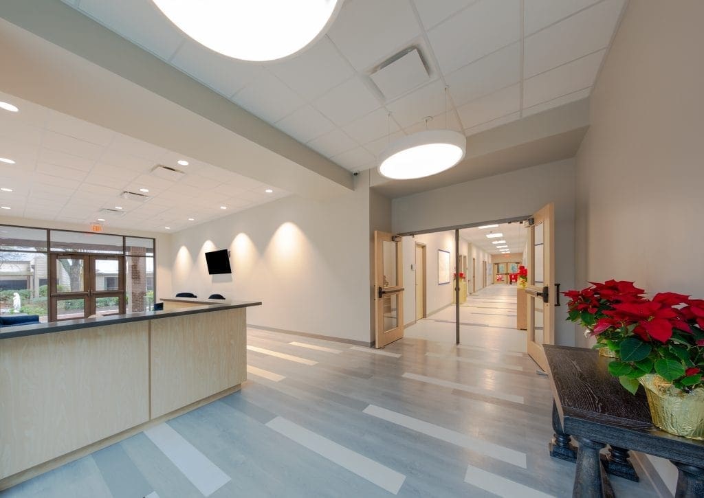 Modern lobby with poinsettia and hallway view.