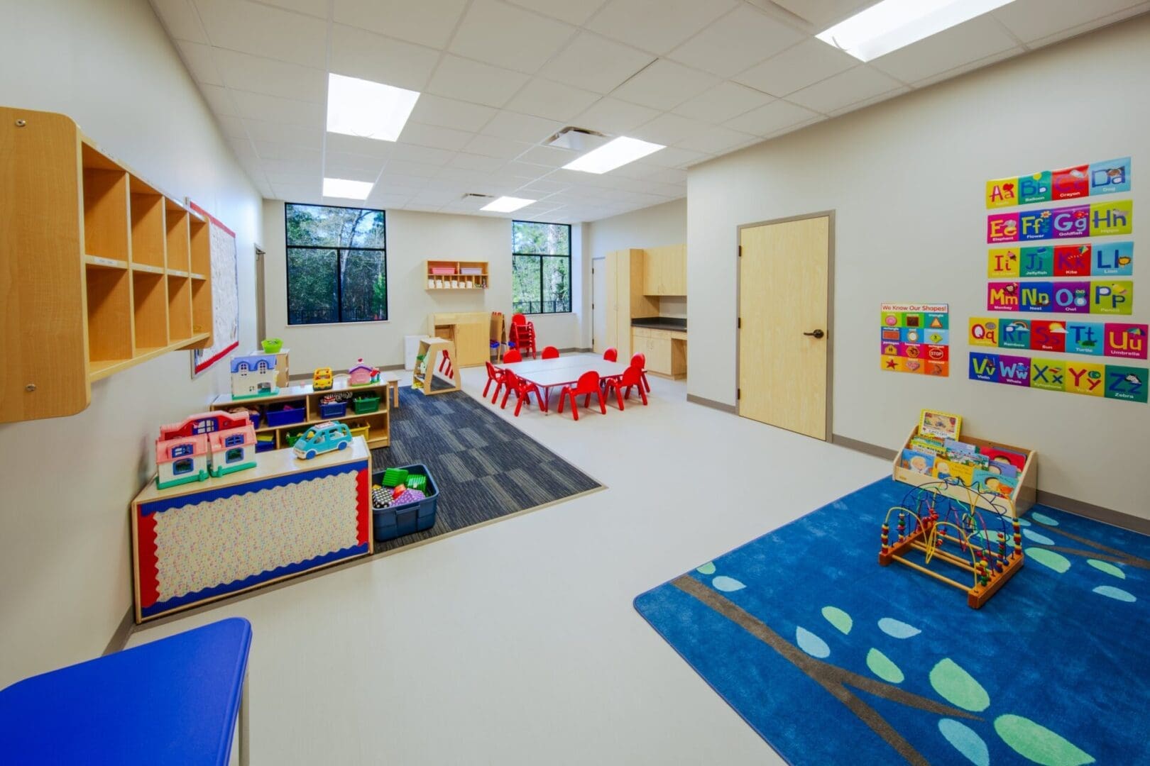 Colorful preschool classroom with toys and tables.