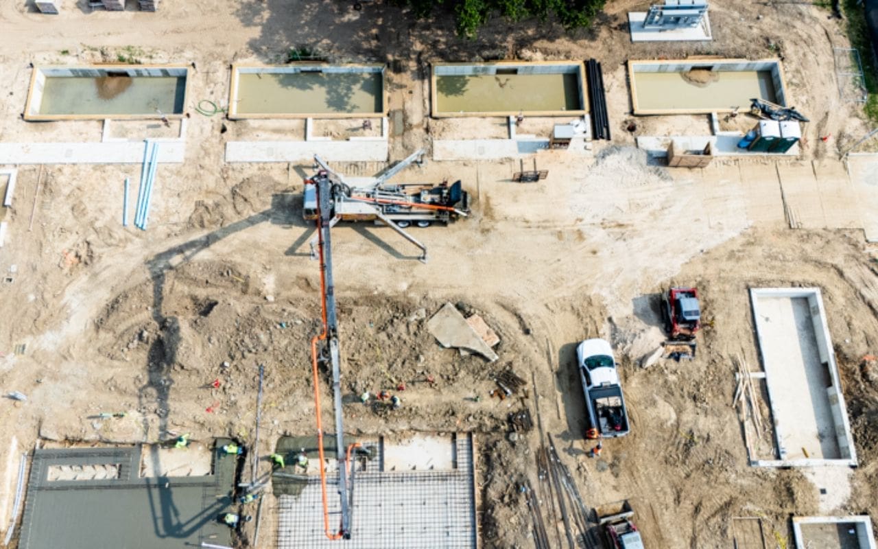 Construction site with machinery and concrete work.