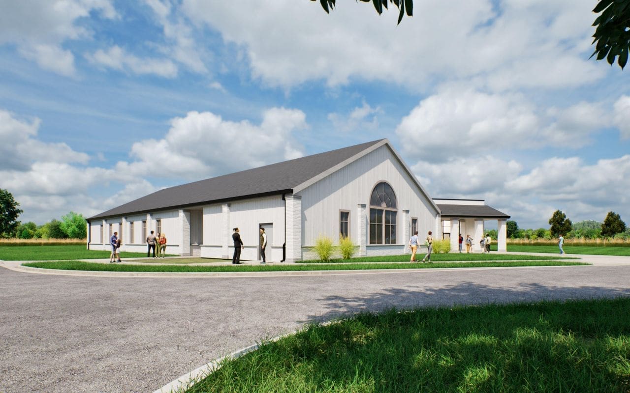 Modern building with people outside, cloudy sky.