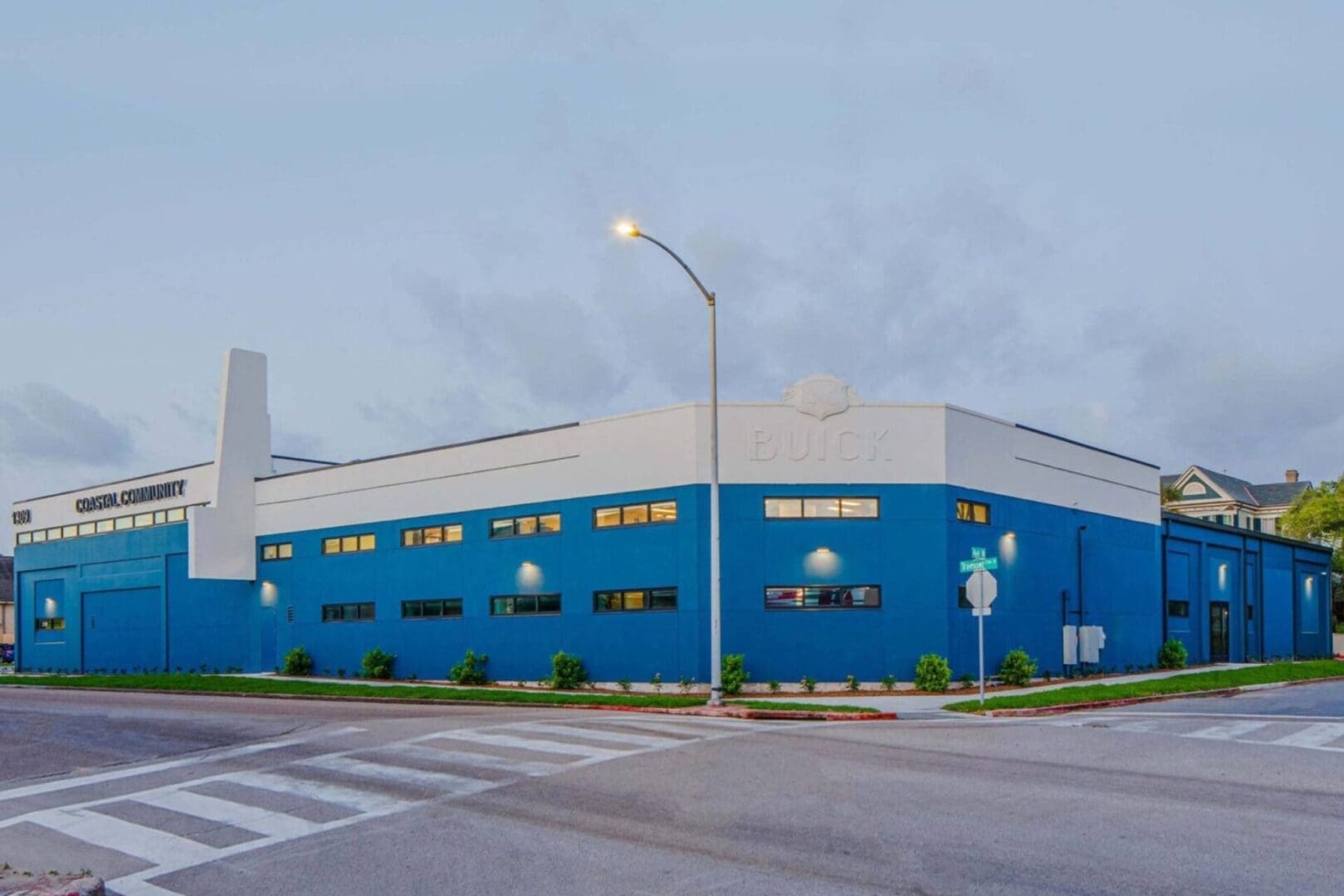 Blue and white industrial building on corner.