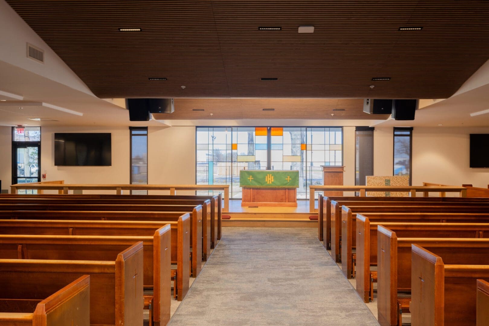 Modern church interior with wooden pews.