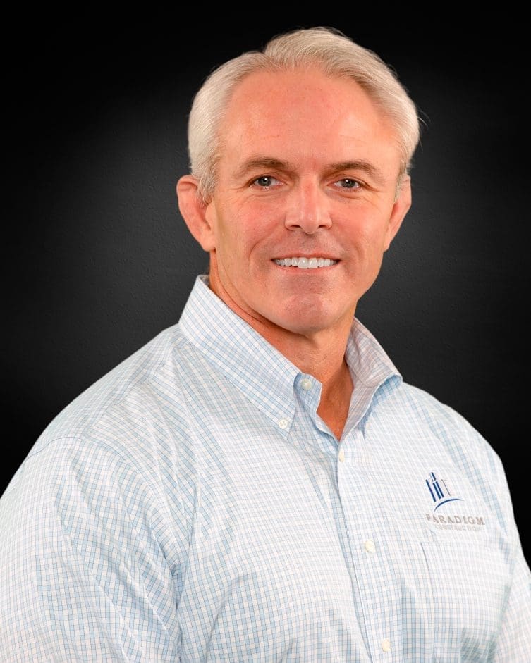 Man smiling in a blue shirt.